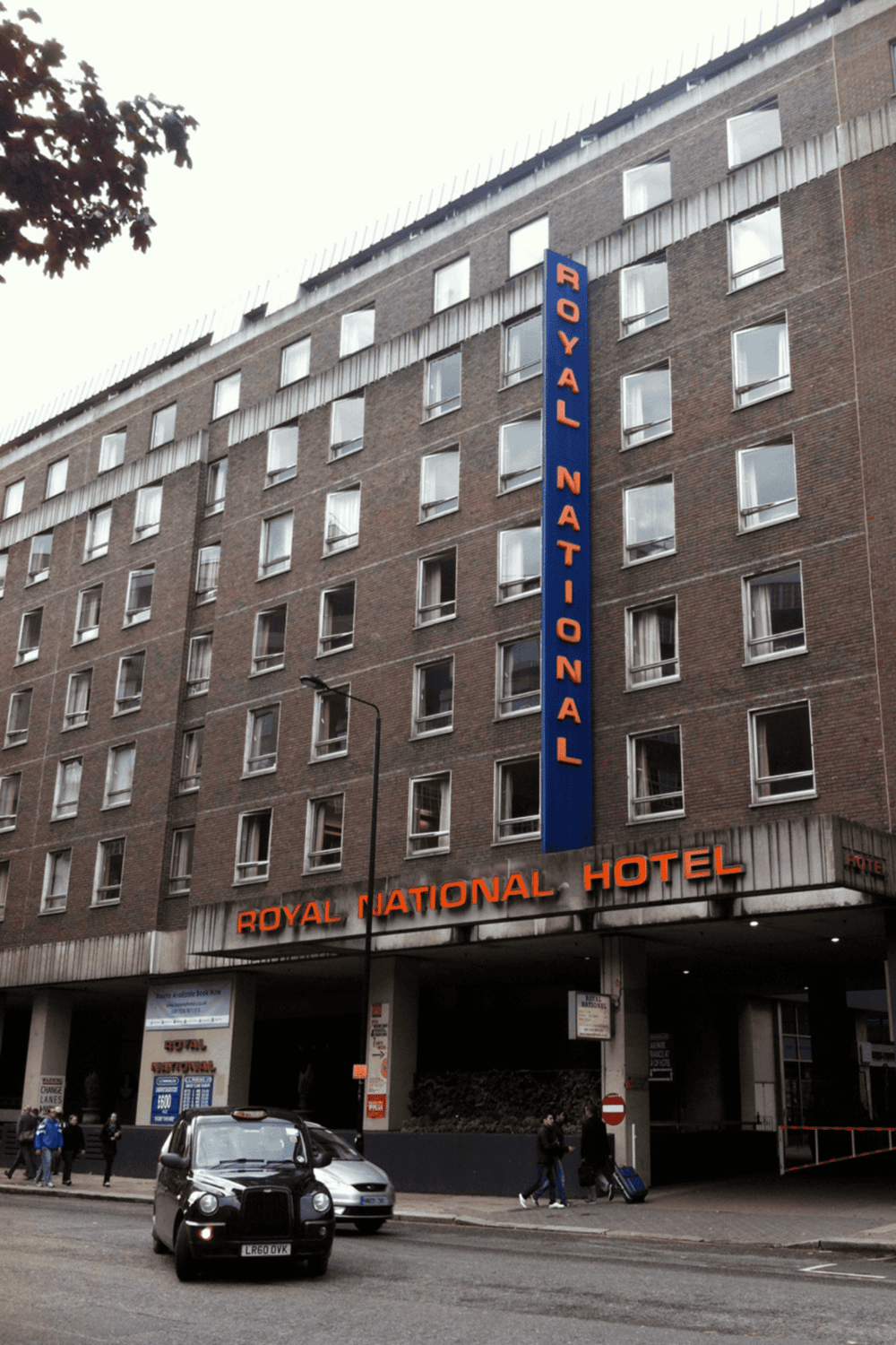 1. historic Royal National Hotel building in London, England, featuring brick facade and neon signage.