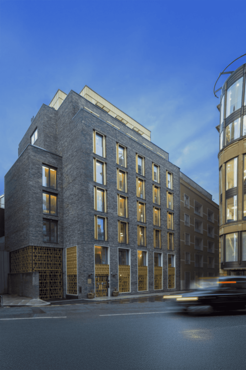 Contemporary urban building with large windows and modern architectural design.