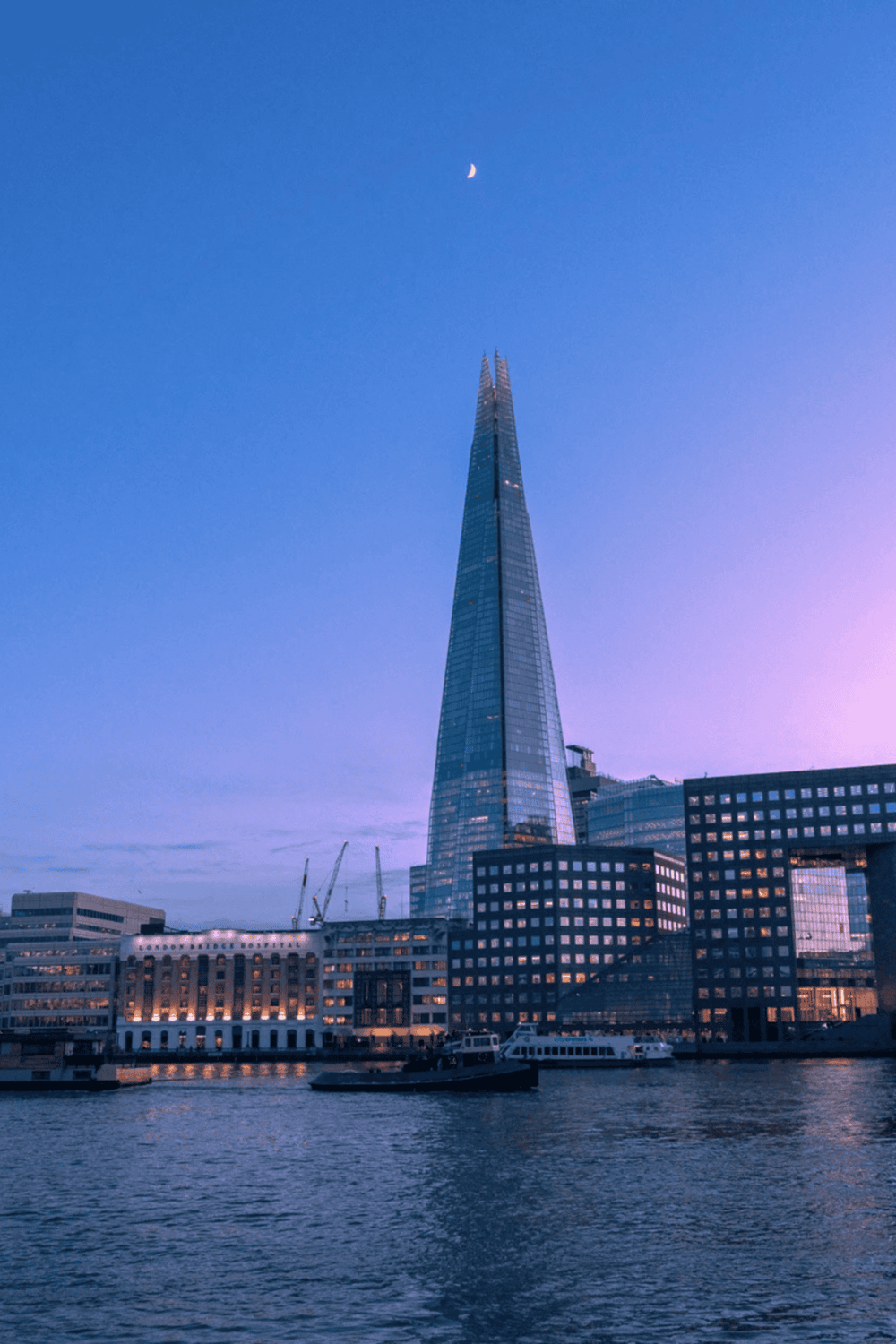 1. Downtown London skyscraper at sunset with Tower Bridge in the foreground.