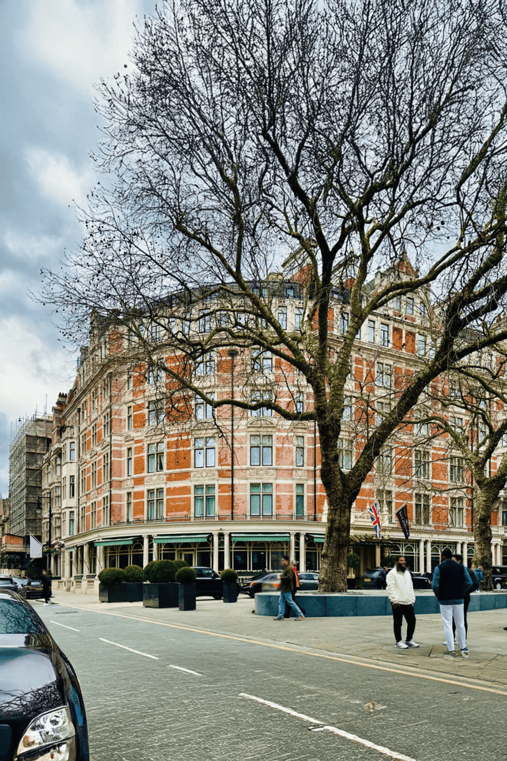 Aerial view of historic brick building with tree in city street, London architecture, QuestForDirections SEO featured image.