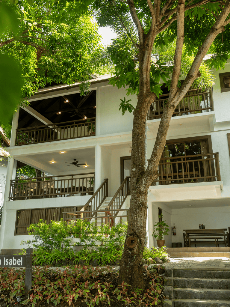 Luxurious tropical resort with modern villas and lush greenery in a serene setting.