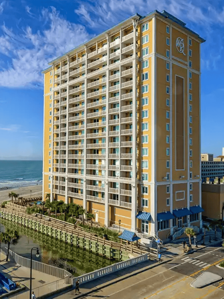 Oceanfront hotel with balcony views and coastal surroundings near the beach.