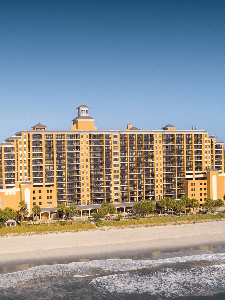 Luxury beachfront hotel with ocean view and private beach access.