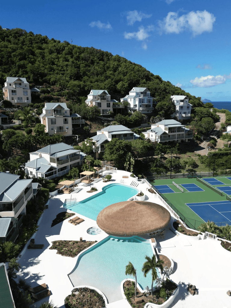 Stylish beachfront villas with swimming pools and tennis courts overlooking the ocean.