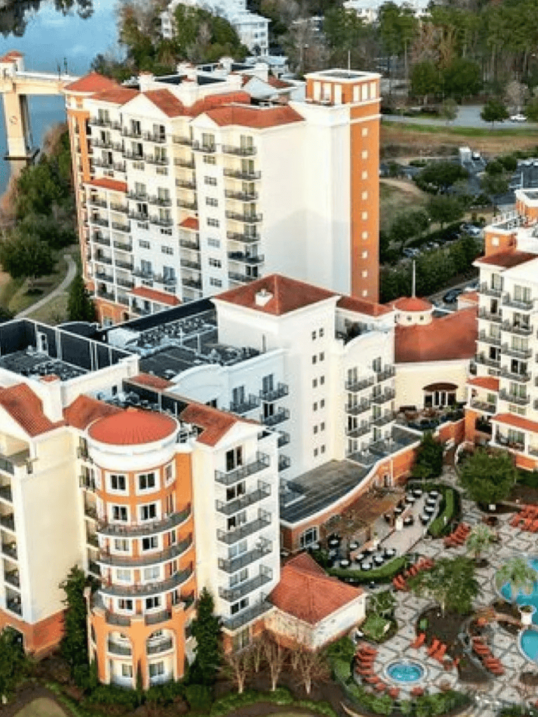 Luxury residential apartment complex with pool and scenic surroundings, offered by QuestForDirections.