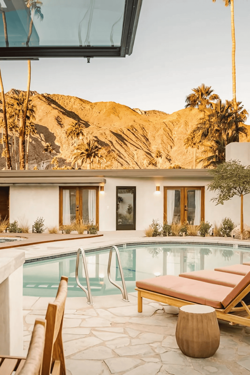 Relaxing poolside view at QuestForDirections vacation rental with mountain backdrop.
