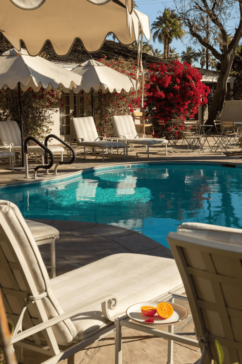 Relaxing hotel pool with lounge chairs and umbrellas, perfect for a vacation retreat.