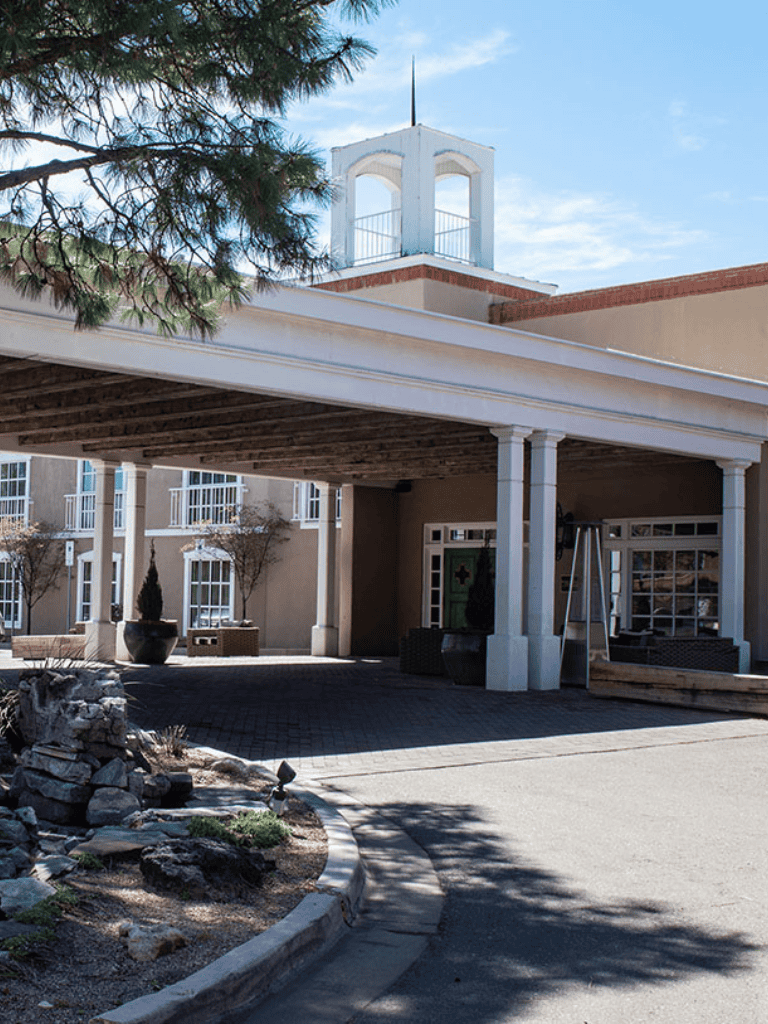 Welcoming assisted living facility with landscaped gardens and cozy outdoor seating areas.