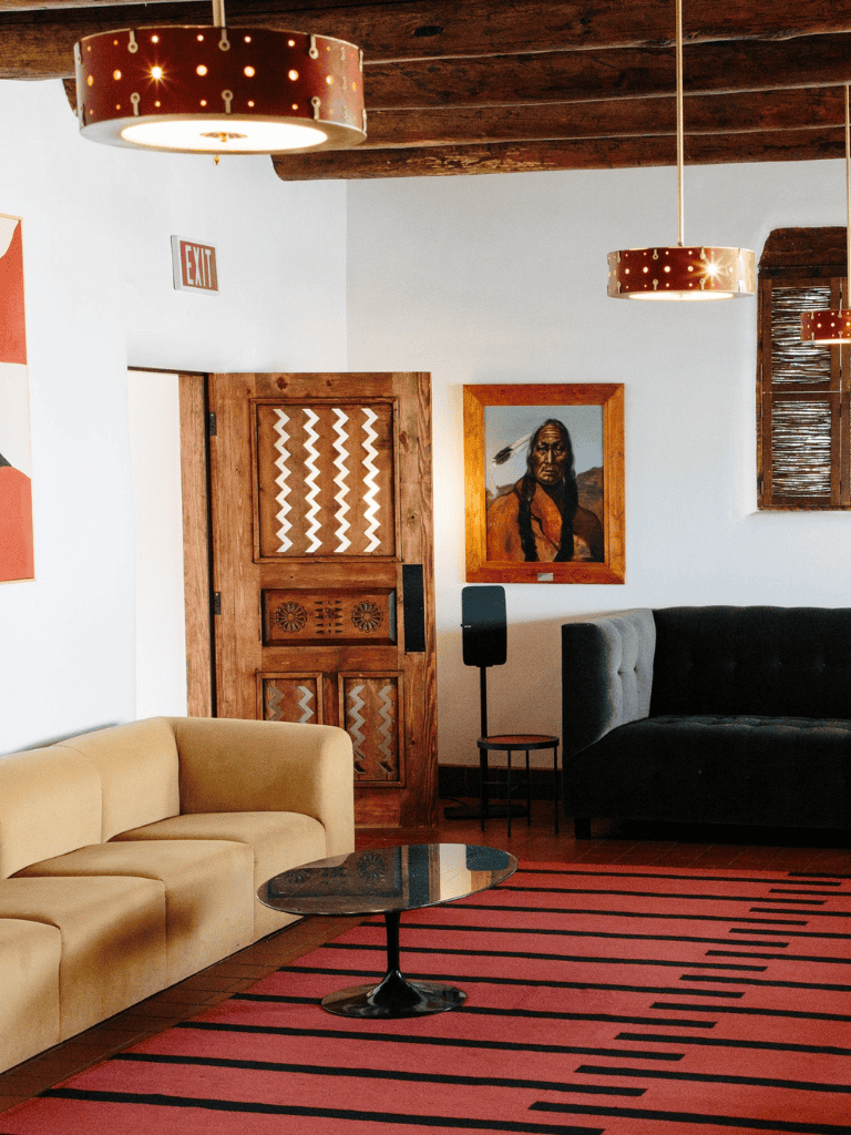 Cozy modern interior with tribal artwork, stylish sofas, and warm lighting for inspiring leadership and community building.