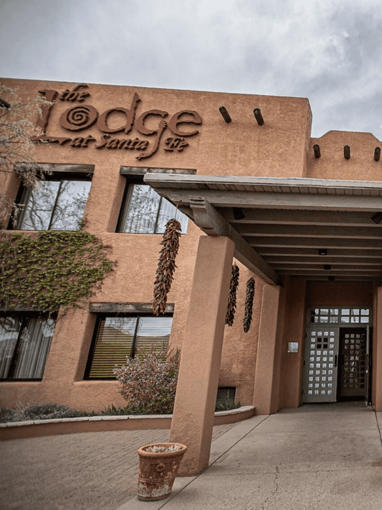 Elegant adobe-style building with "The Edge" sign in Santa Fe, New Mexico.