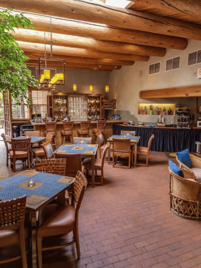 Cozy restaurant interior with wooden beams and warm lighting, perfect for dining and socializing.