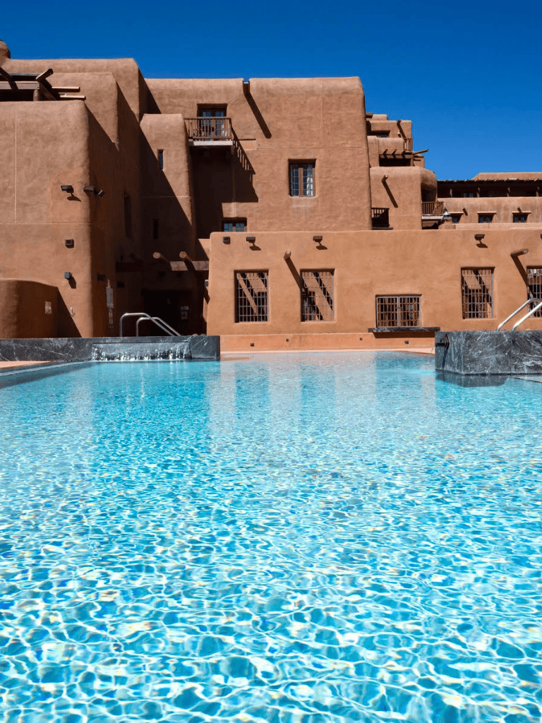 Relaxing desert-style hotel pool with southwestern architecture and vibrant blue water.
