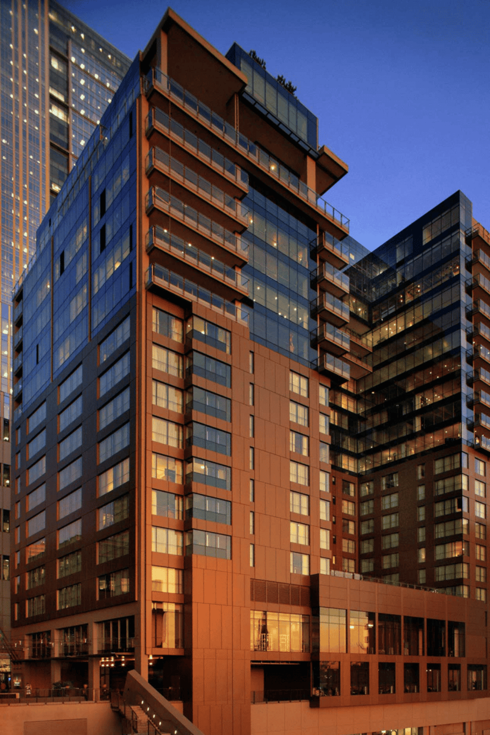 Luxury modern high-rise building with glass exterior in downtown city.