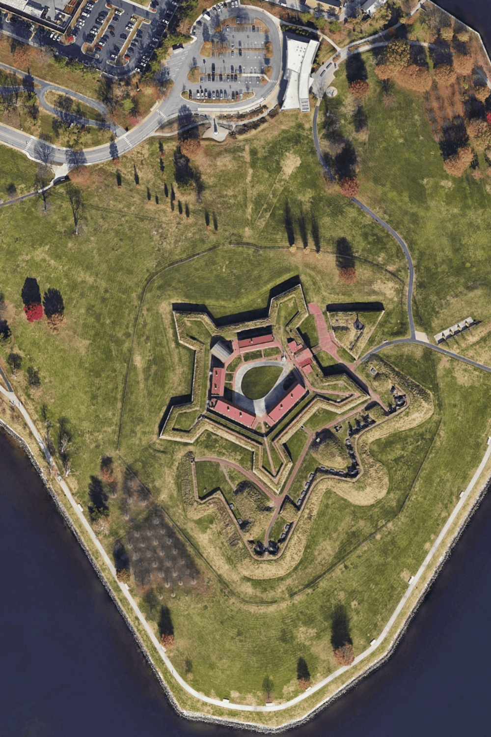 1. Aerial view of historic star-shaped Fort Monroe with moat and green parks in Virginia.