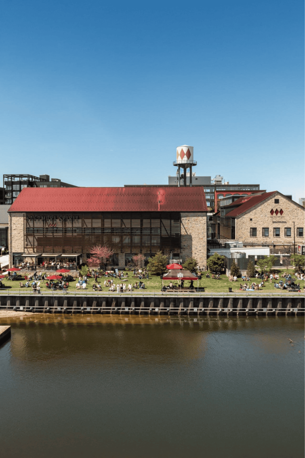 Historic warehouse converted into a vibrant riverfront restaurant with outdoor seating and city views, in Austin, Texas.