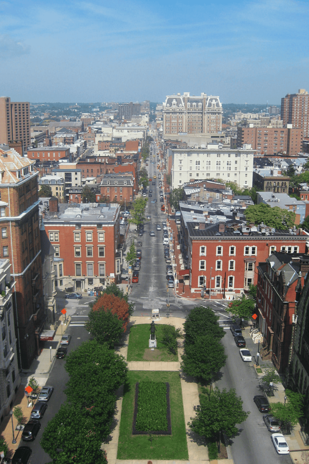 Historic downtown cityscape with lush park and classic architecture, highlighting urban exploration and city tours.