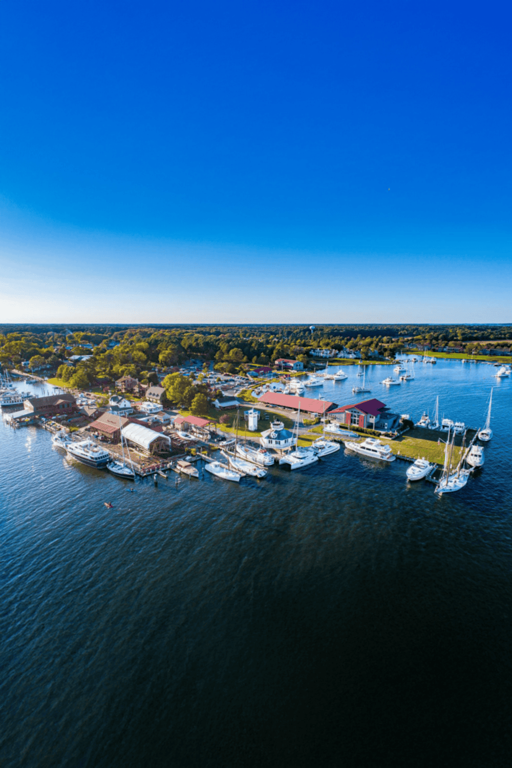 Boating marina with sailboats and yachts on a sunny day.