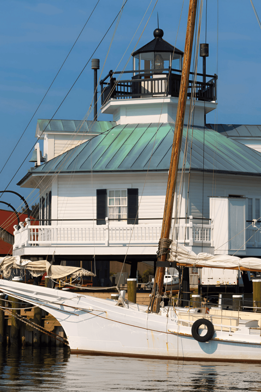 Boating lighthouse house on the water, maritime navigation, coastal scenery, nautical landmark, seaside structure, port house, sailboat, waterfront building, boating destination, coastal lighthouse.