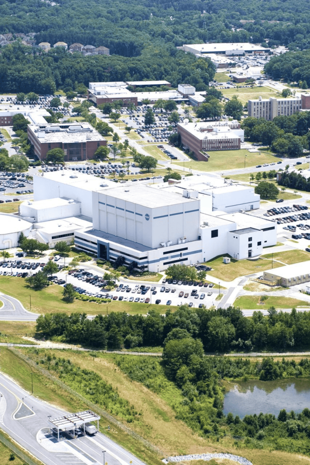 Aerial view of Quest for Directions facility with parking lot and surrounding greenery.