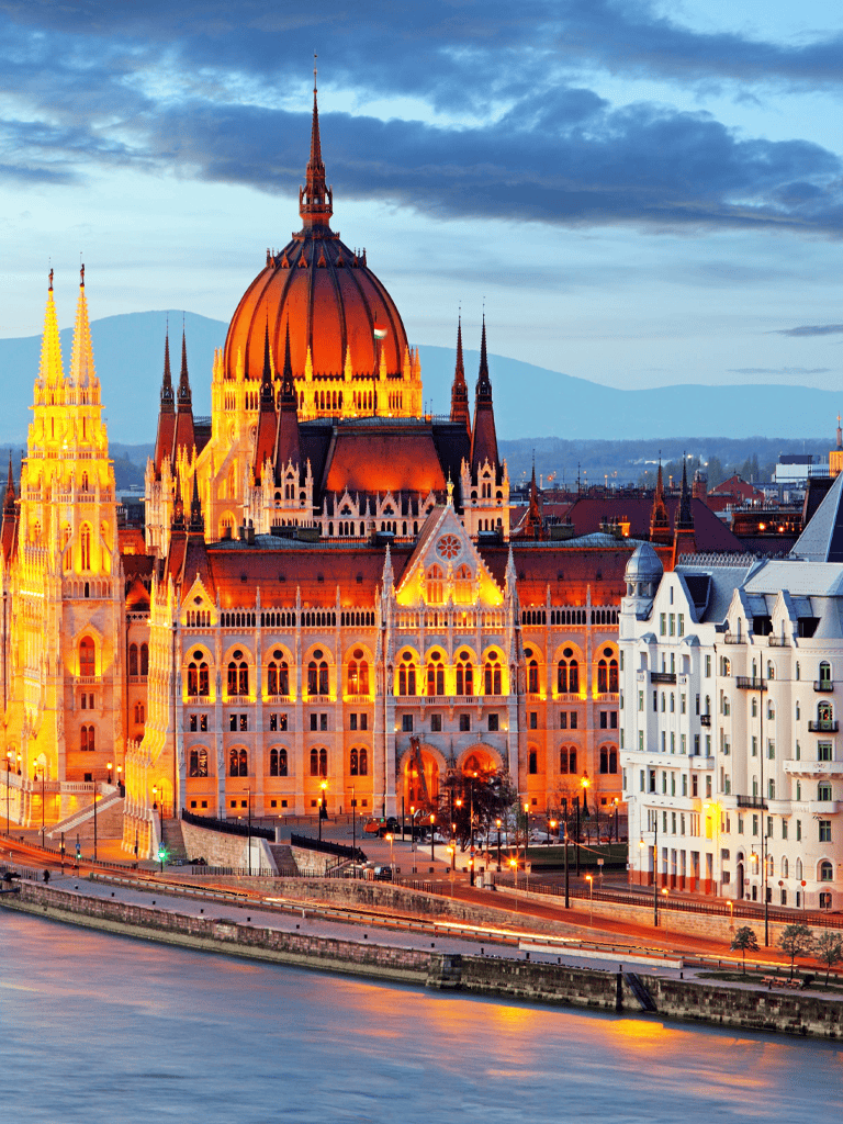 Majestic Hungarian Parliament Building illuminated at sunset in Budapest.