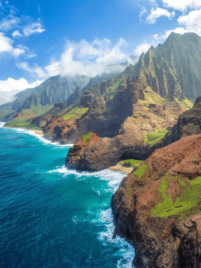 Vibrant coastal cliffs and turquoise ocean at Na Pali Coast, Hawaii, showcasing natural beauty and scenic hiking routes.
