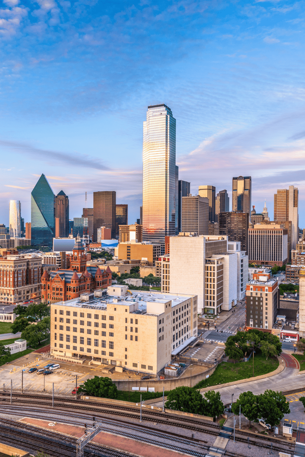 Modern Dallas skyline with skyscrapers and downtown buildings during sunset.