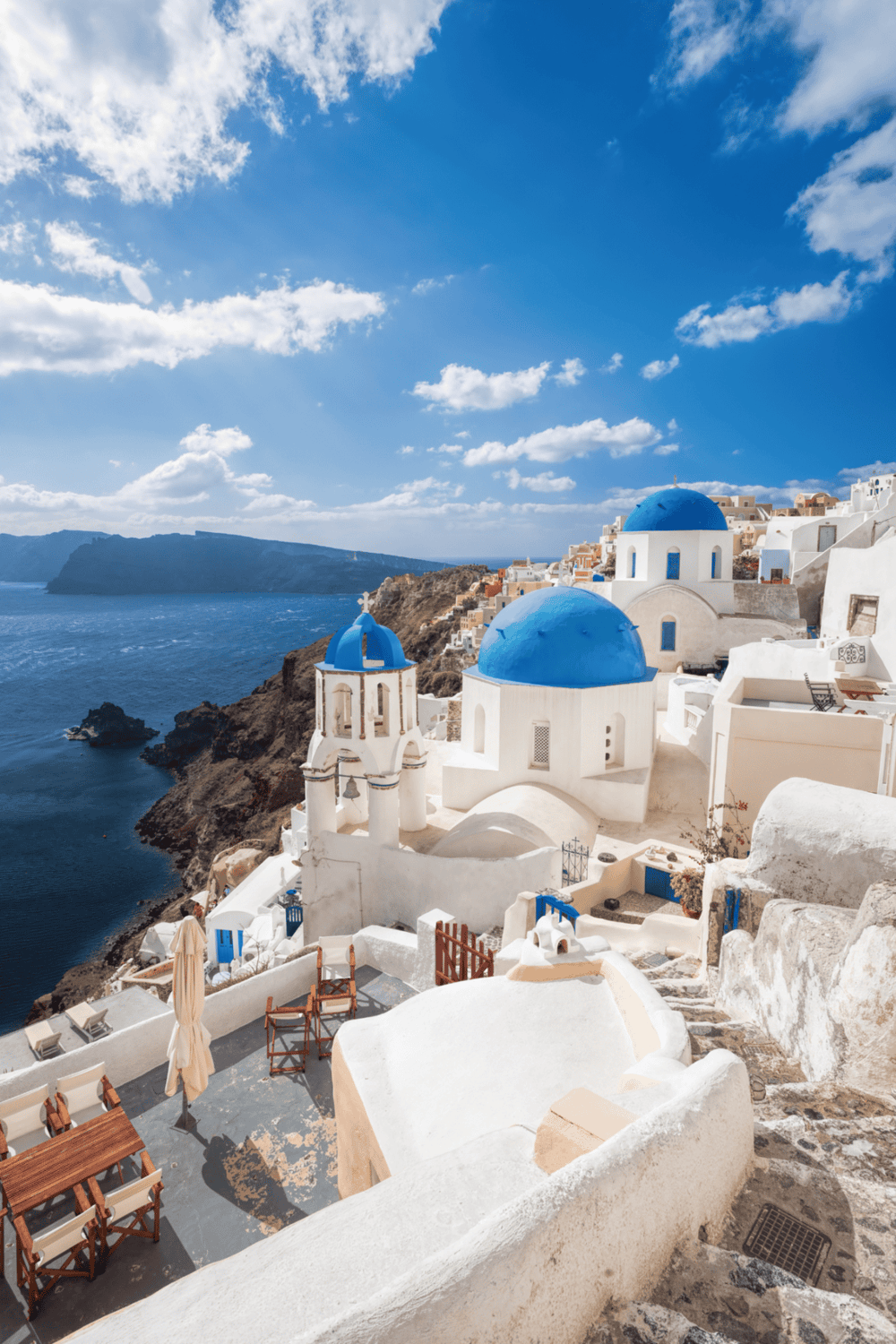 Vibrant Greek island architecture with iconic white buildings and blue domes overlooking the sea.