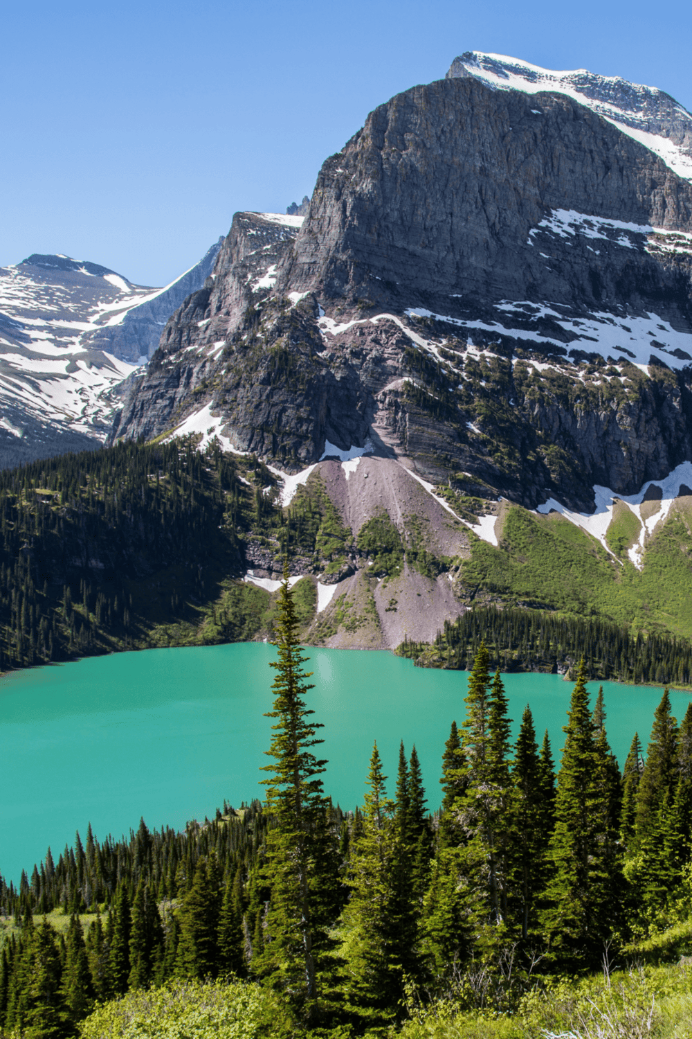 Stunning mountain landscape with turquoise lake and snow-capped peaks at QuestForDirections.