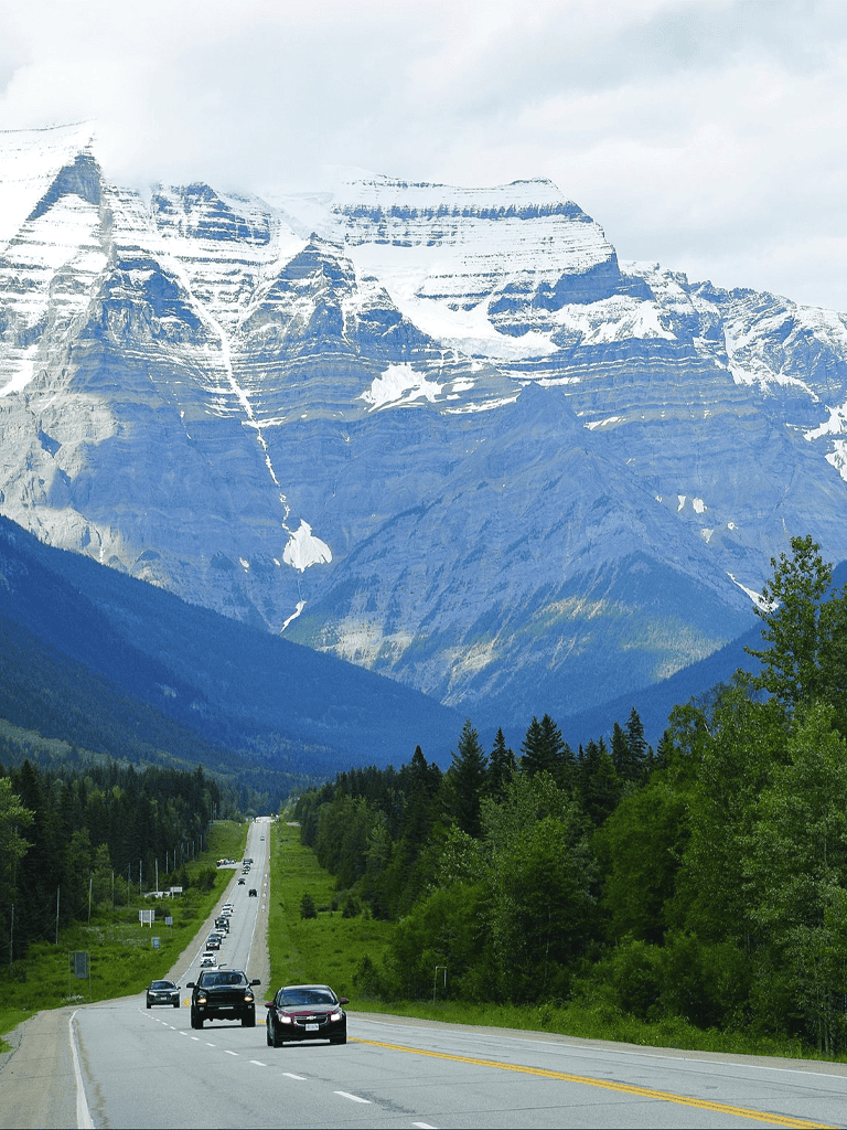 Highway views with mountains and snow-capped peaks in the background.