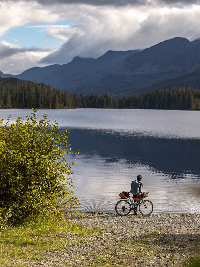 Climber enjoying scenic mountain lake view for outdoor adventure and nature exploration.