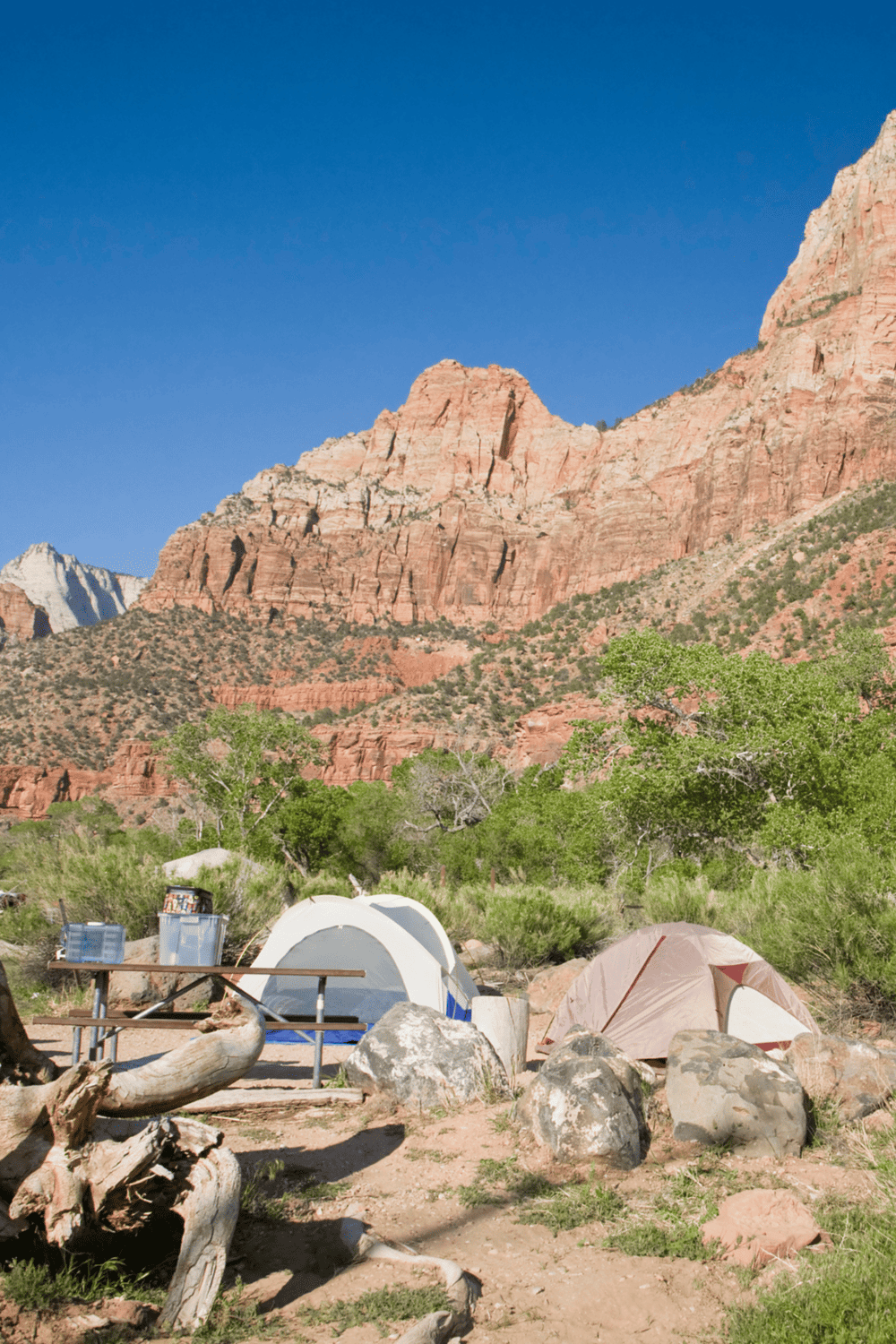Seaside camping tents with scenic red rock mountain background, outdoor adventure, nature hiking, camping gear.