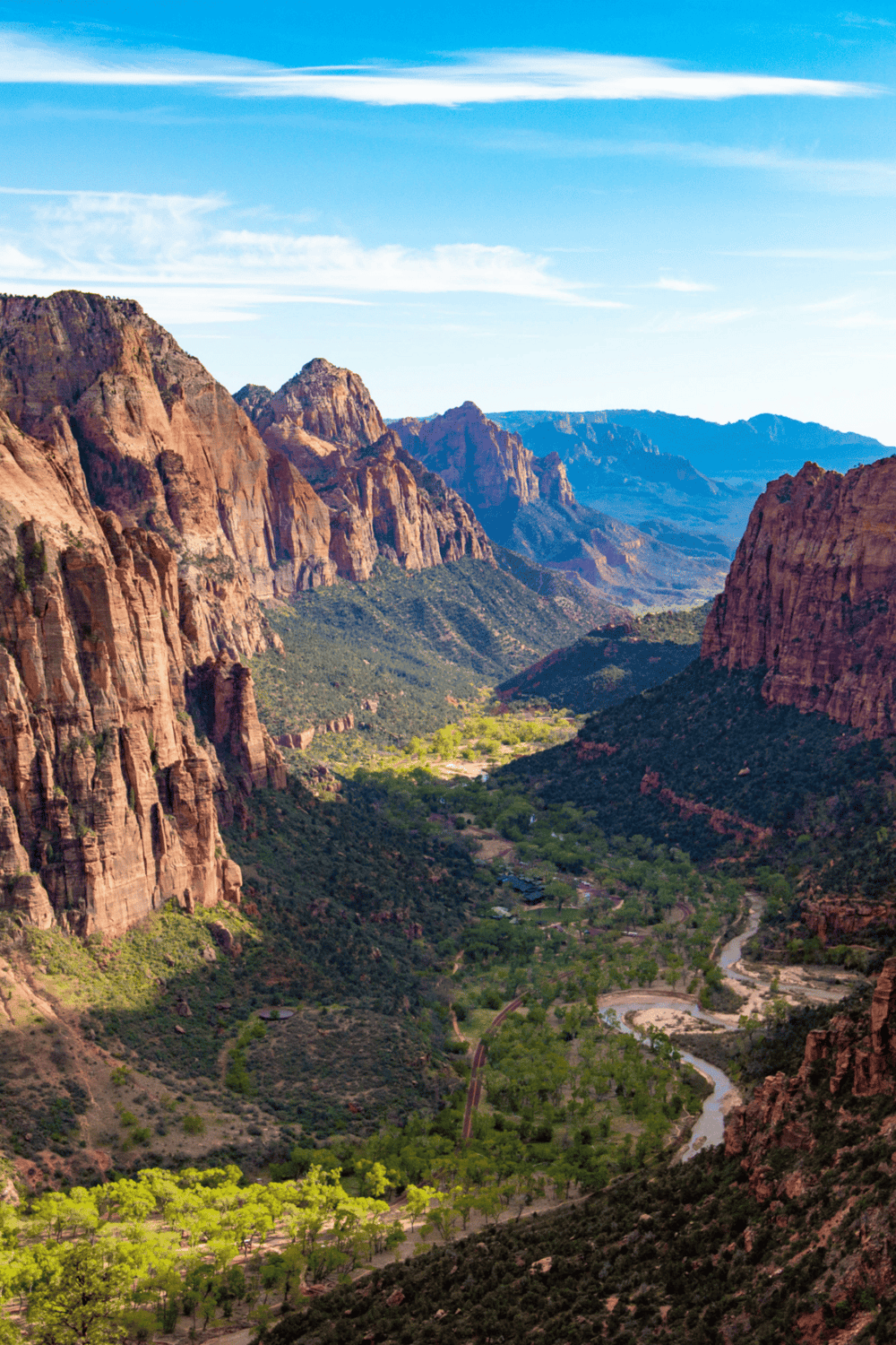 Vivid view of Zion Canyon in Utah, showcasing stunning red rock formations and lush green valley.