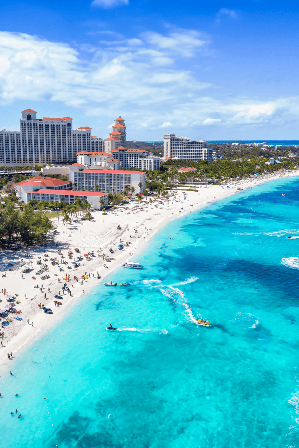 Luxurious beachfront hotels on a tropical coastline with blue waters and white sandy beaches for vacation.
