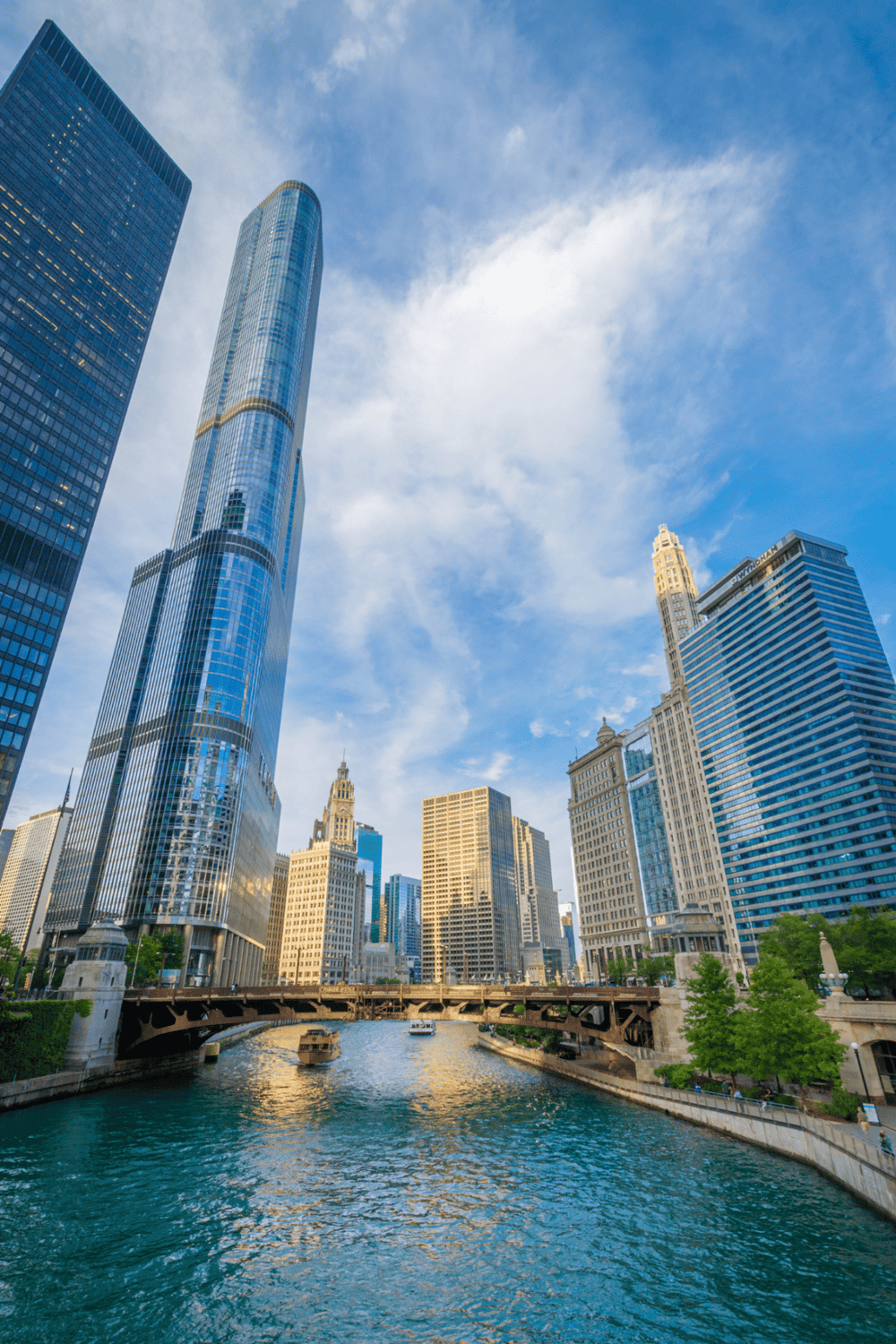 Skyscrapers in Chicago skyline with river and blue sky, modern urban cityscape.