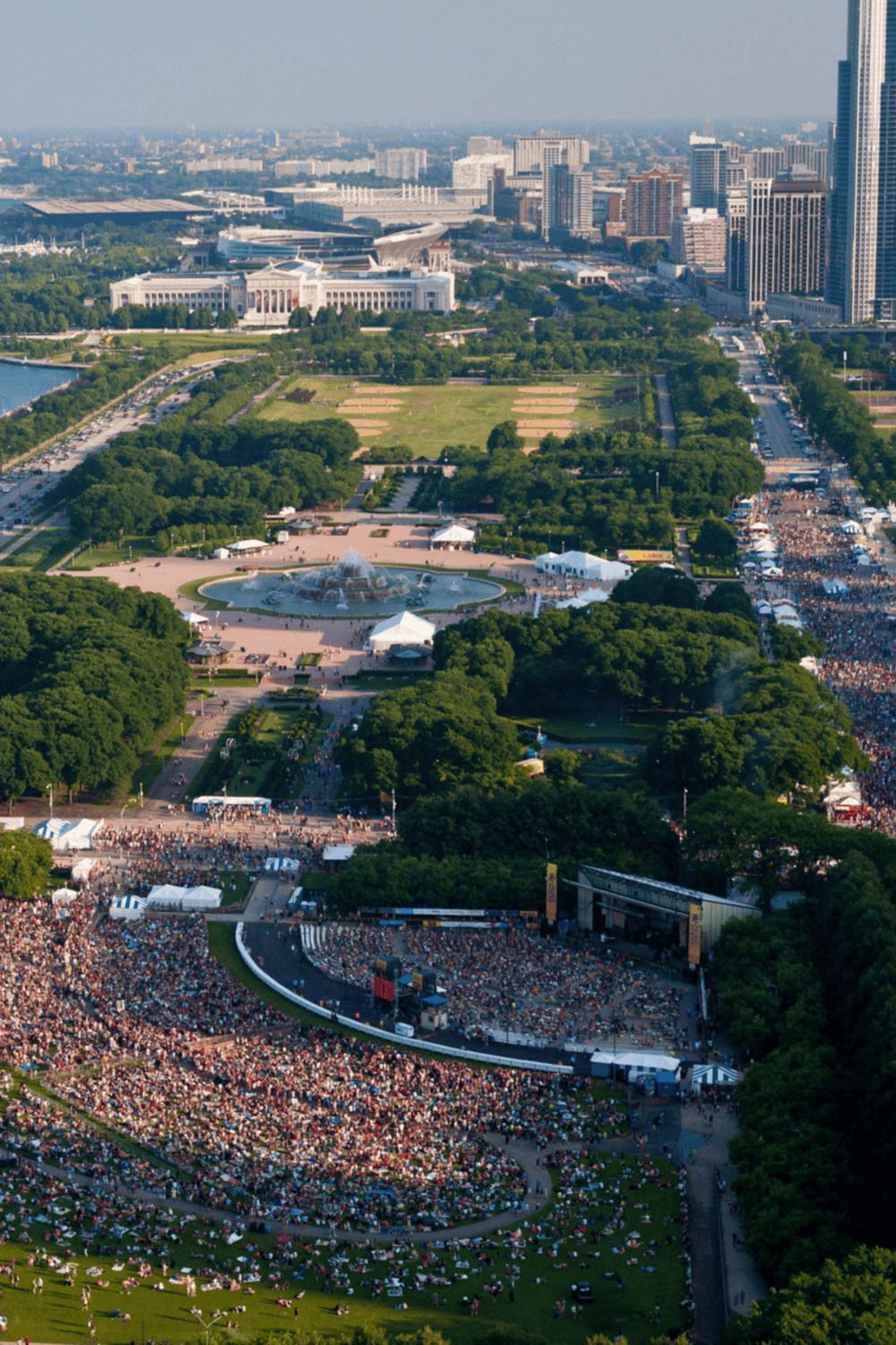 Aerial view of the National Mall in Washington, D.C., during a large outdoor event with crowds and stage performances.