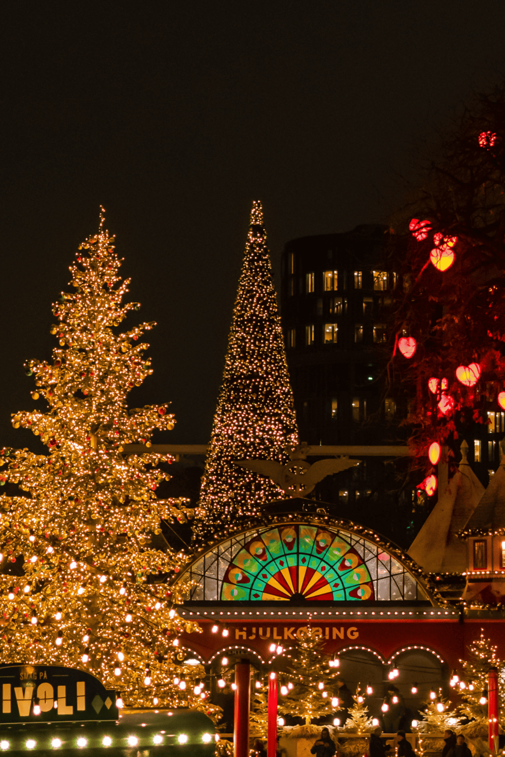 Festive Christmas trees with lights at QuestForDirections holiday event, offering family fun and holiday shopping.