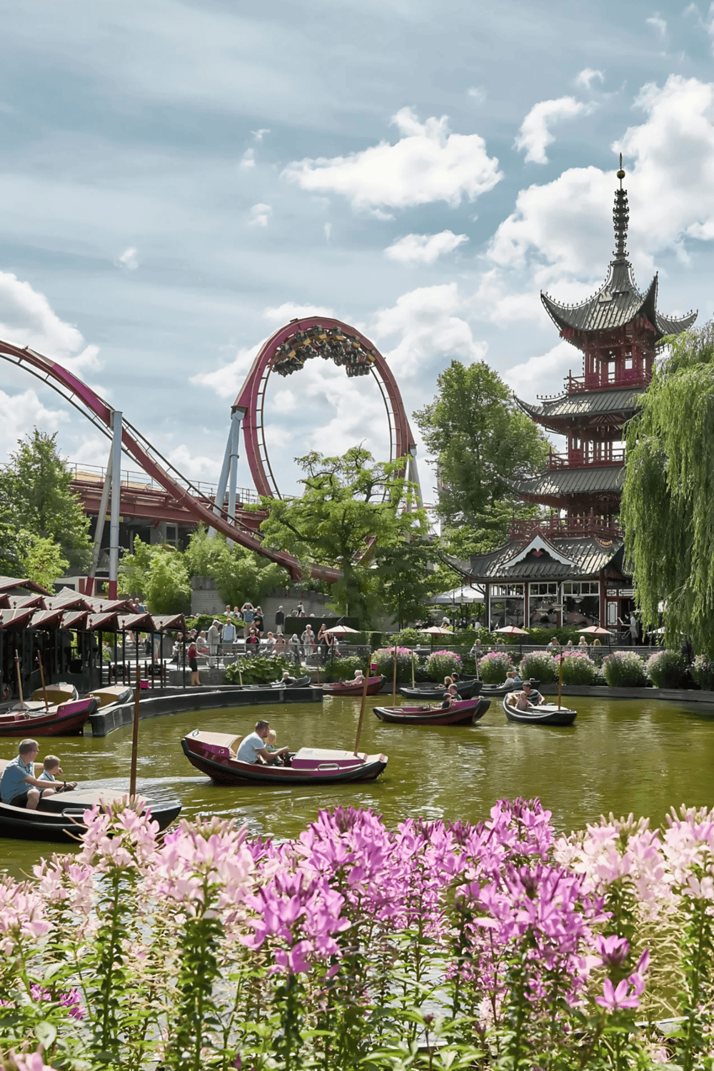 Thrill rides at Quest for Directions amusement park with roller coaster and traditional pagoda-style building.