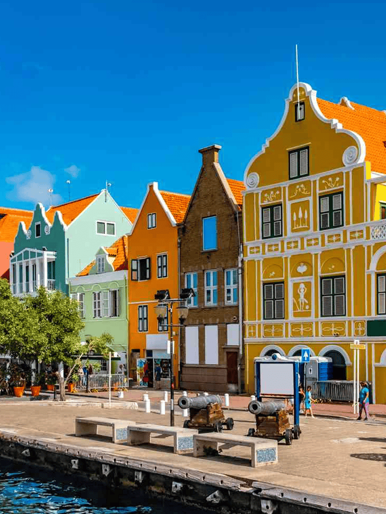 Colorful European houses along waterfront, vibrant travel destination, QuestForDirections.