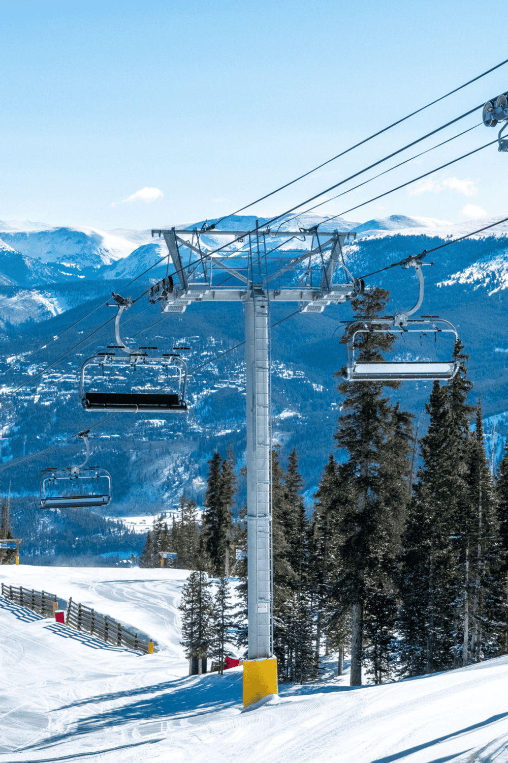 Snowy ski resort with chairlift and mountain scenery for outdoor adventure travel.