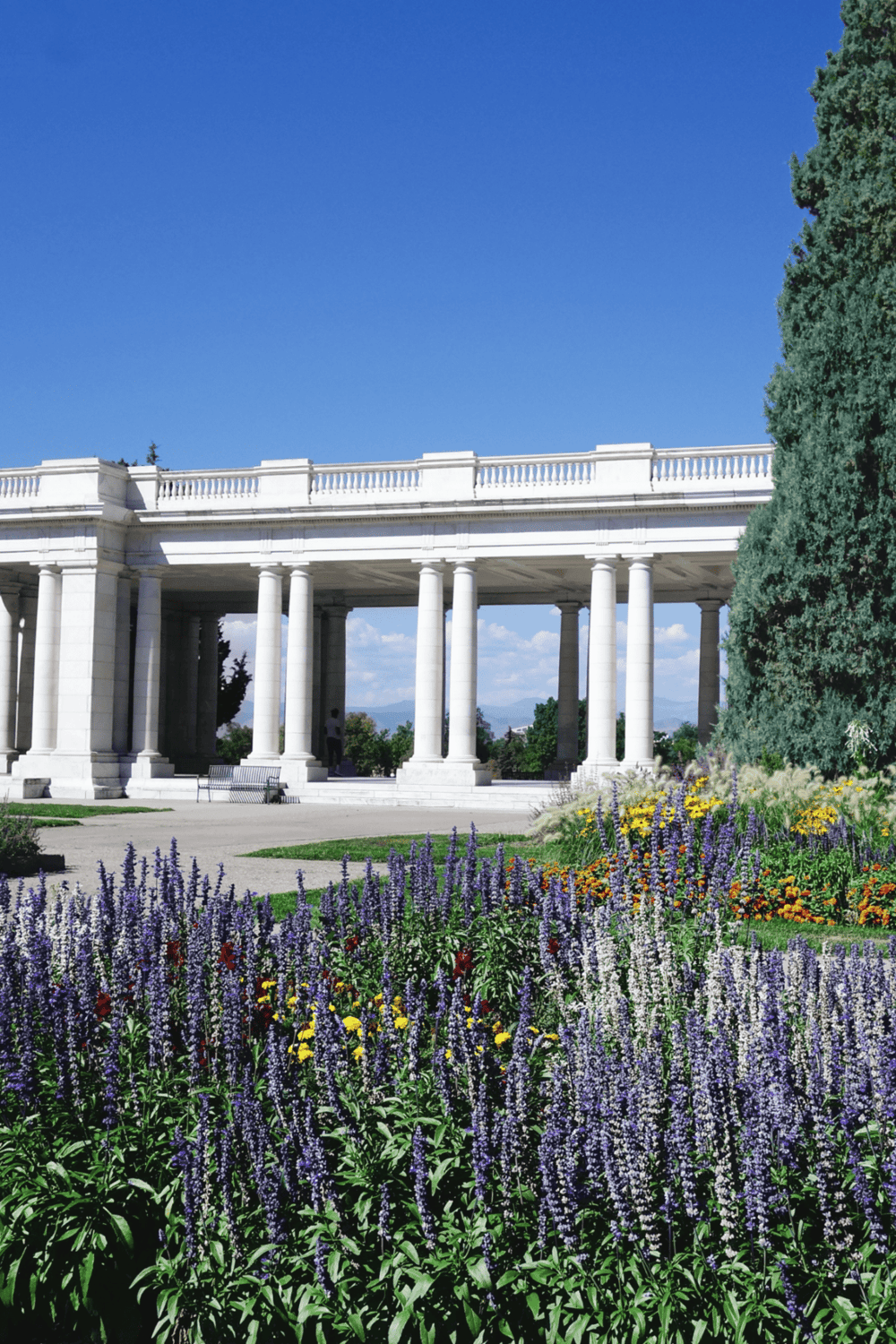 Vibrant garden and classical white structure at QuestForDirections, scenic outdoor location.