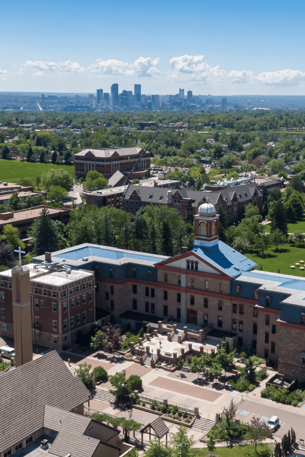 Aerial view of downtown Denver with city skyline and historic church, showcasing Colorado's architecture and vibrant community.