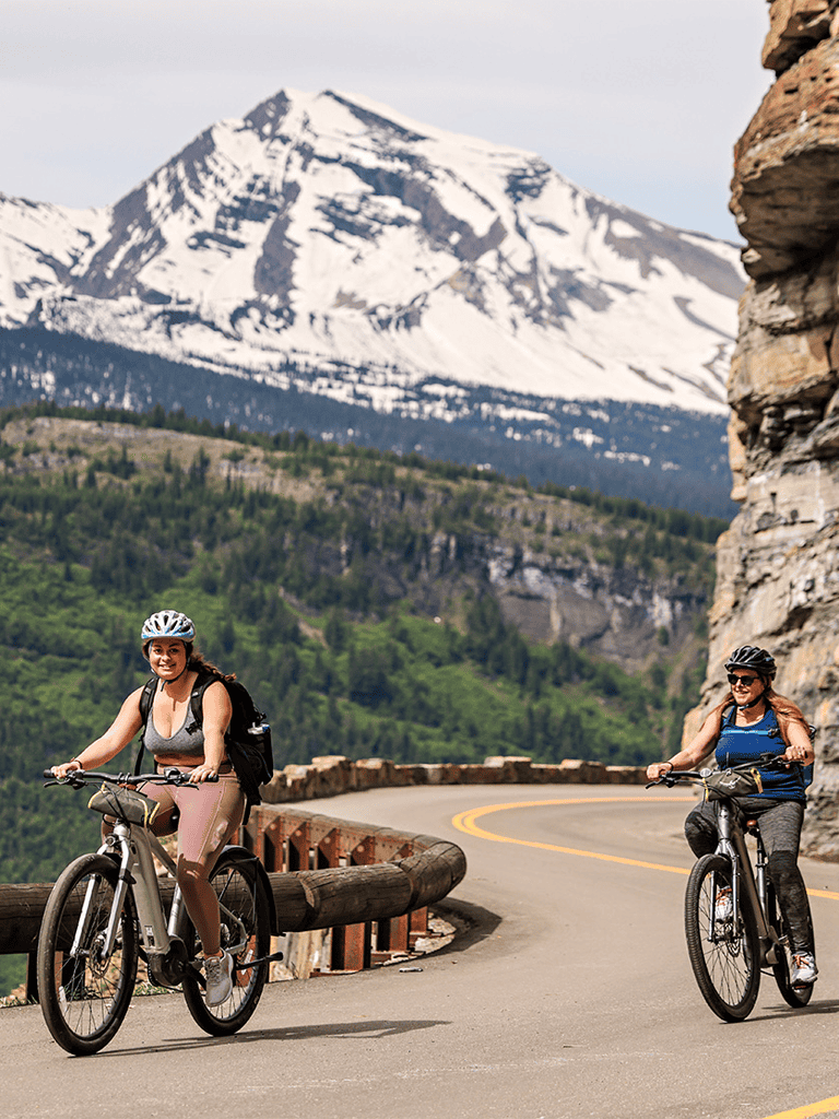 Golden Mountain with cyclists riding along a scenic mountain road, QuestForDirections outdoor adventure.