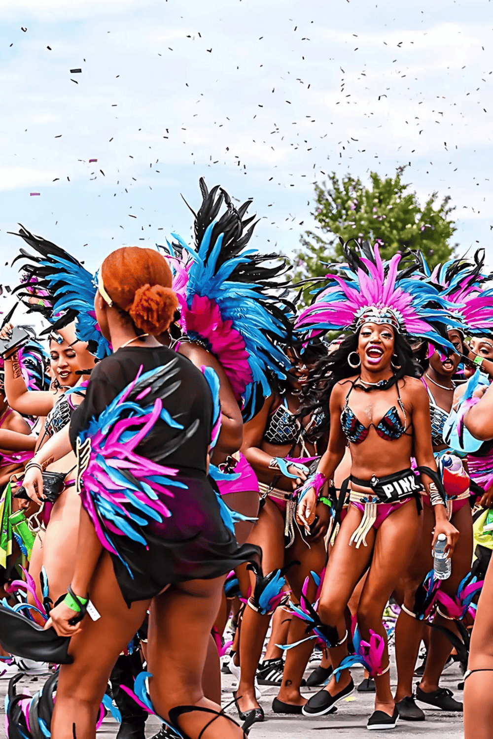 Colorful carnival dancers in vibrant costumes at a street festival, showcasing celebration and cultural diversity.