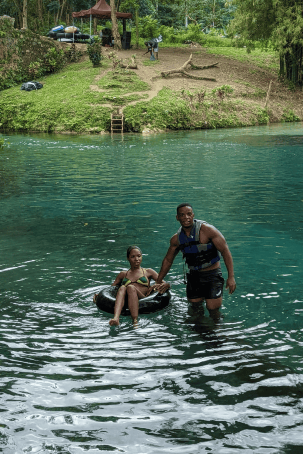 Relaxing river swim with friends at QuestForDirections outdoor adventure site.
