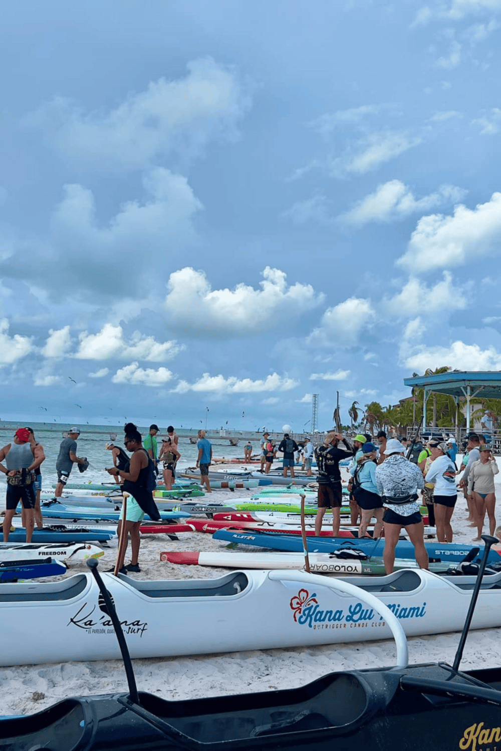 Kayak rental beach scene with kayaks and paddleboards, tropical ocean, sunny weather, fun outdoor water activity, Miami, Florida.