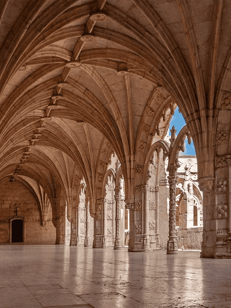 Intricate stone arches in a historic cloister, showcasing Gothic architecture and craftsmanship.
