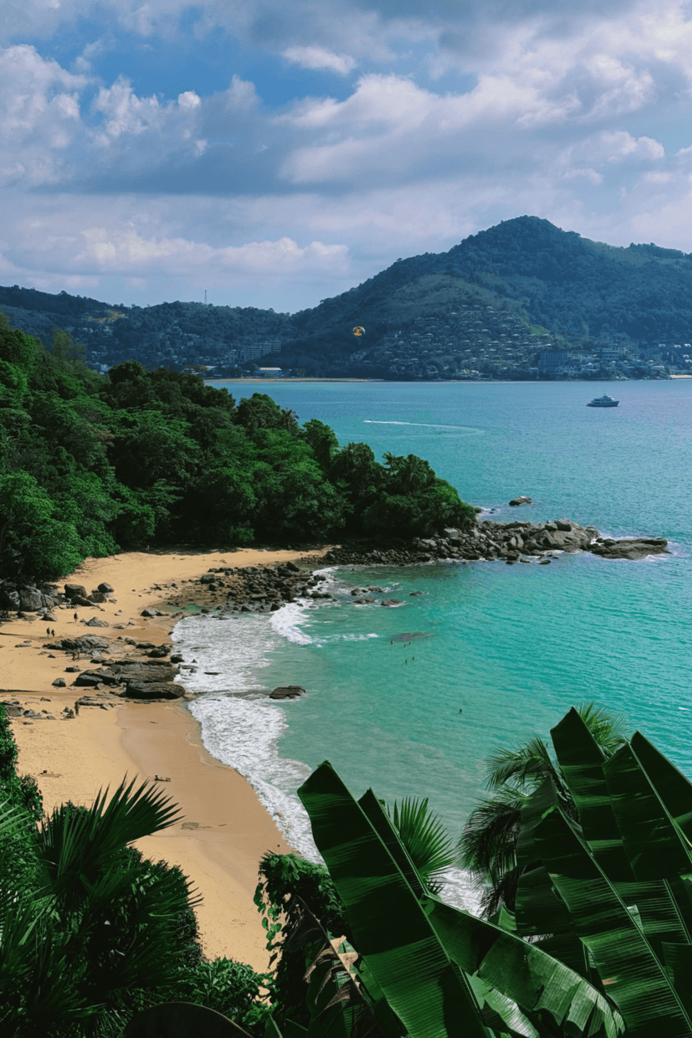 Tranquil tropical beach with lush greenery, clear turquoise waters, and scenic mountain views.