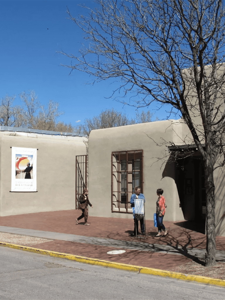 Quiet outdoor scene at Quest for Directions art and cultural center, with visitors enjoying a sunny day.