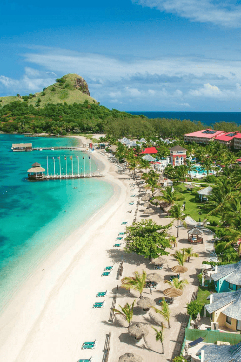 Relaxing tropical beach resort with clear blue waters and lush greenery.