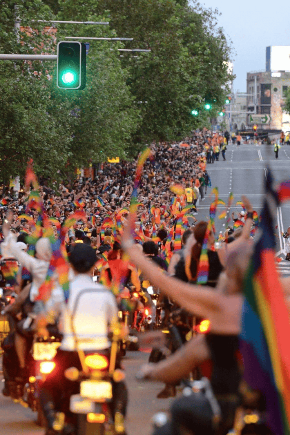 Rainbow flags at Pride parade downtown celebrating LGBTQ+ community and equality.